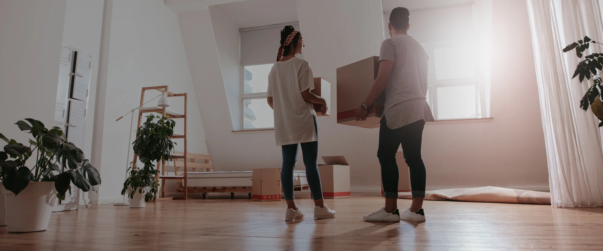 People standing in a home with boxes